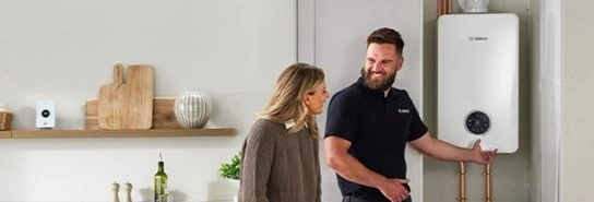 Installer with customer in front of Worcester Bosch boiler